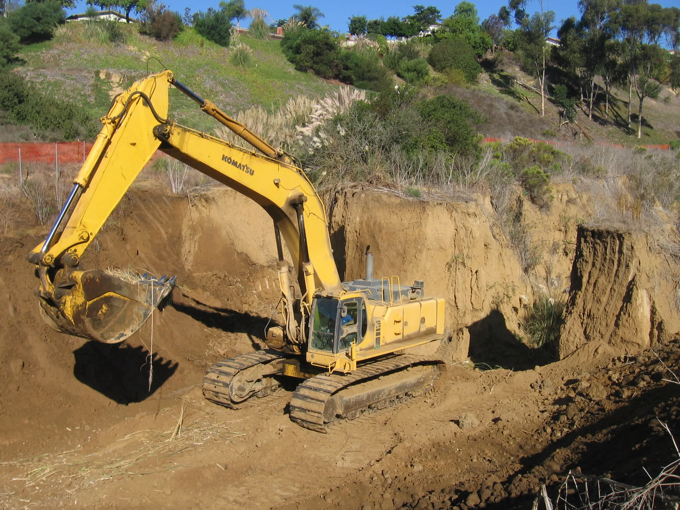 Excavator performing hillside grading at Alta La Jolla