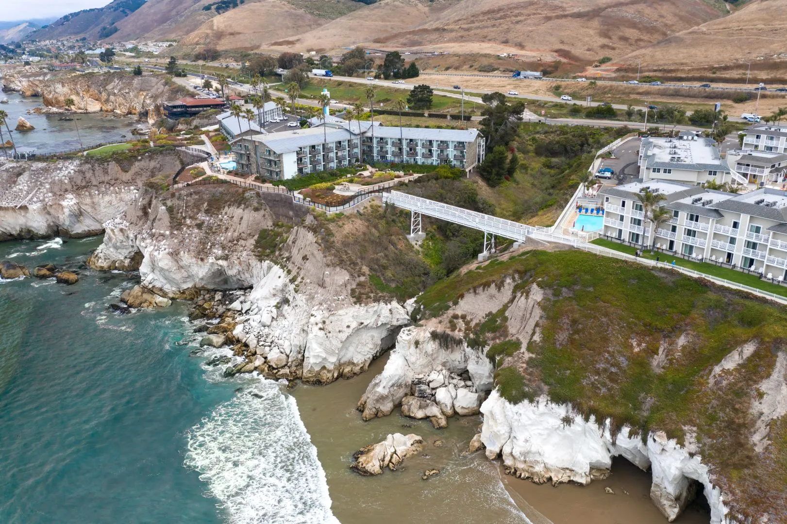 Aerial view of the Martin Resorts pedestrian bridge spanning the coastal canyon at Pismo Beach