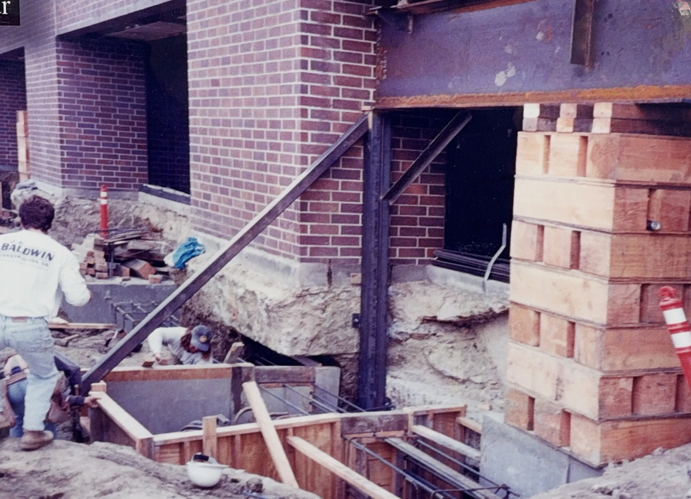 Underpinning excavation and temporary shoring beams along the Planet Pacific building perimeter