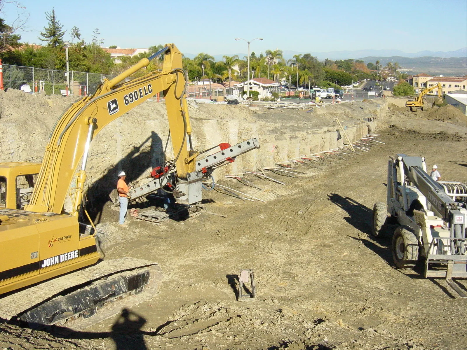 Heavy equipment performing landslide stabilization at a commercial site