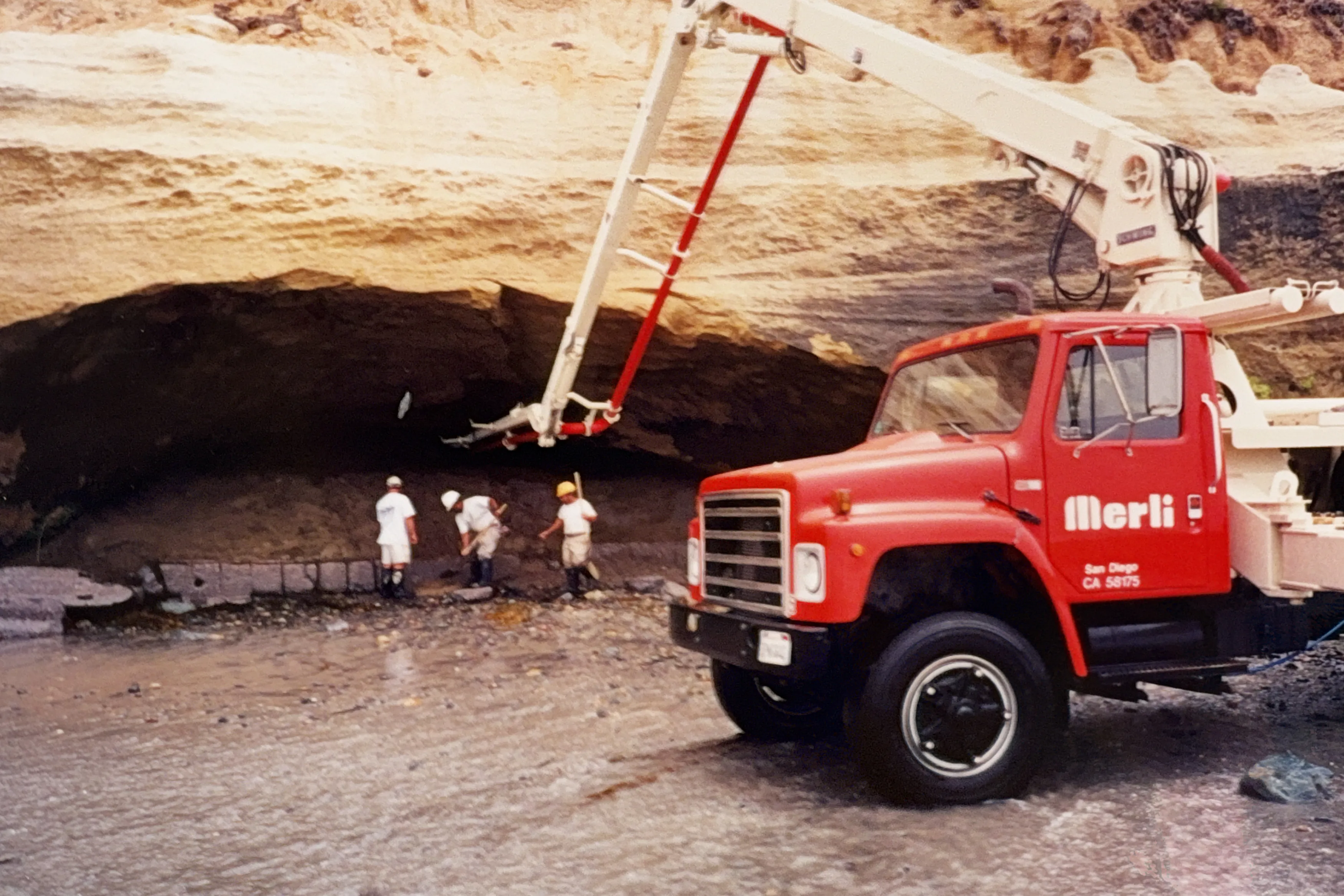 Crew and crane working inside a large sea cave