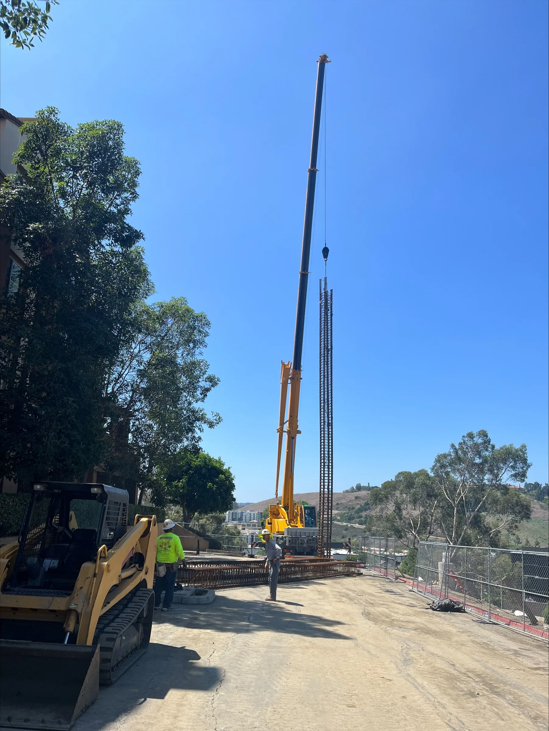 Crane lowering a CIDH pile rebar cage at the Camden Crown Valley slope repair